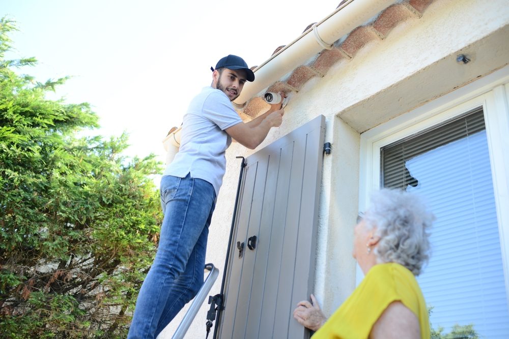 Man installing cameras on senior's home